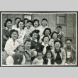 Photograph of a group of people posing in front of the Manzanar hospital (ddr-csujad-47-210)