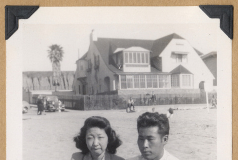 Woman and man on a blanket at the beach (ddr-densho-542-330)