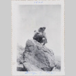 Two women sitting on a boulder (ddr-densho-464-64)
