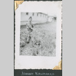 Man digging outside barracks (ddr-densho-434-160)
