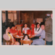 Five people and small child seated at table with gifts (ddr-densho-426-1220)