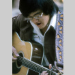 Alan Tani playing guitar (ddr-densho-336-799)