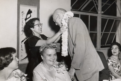 Gilbert Bowles receiving a lei from the Japanese Consul General's wife (ddr-njpa-2-85)