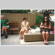 Tomi Iino and young woman eating food outside shopping center. (ddr-densho-368-314)