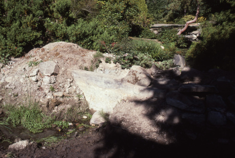 Creek bed looking toward half-rebuilt Heart Bridge (ddr-densho-354-1114)