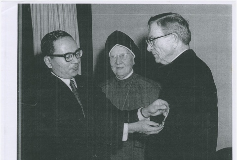 Medal ceremony with priest, nun and man (ddr-densho-330-299)
