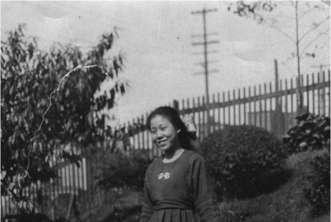 Woman standing in Maneki Garden (ddr-densho-166-4)
