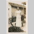 Woman standing in yard outside house (ddr-densho-426-2038)
