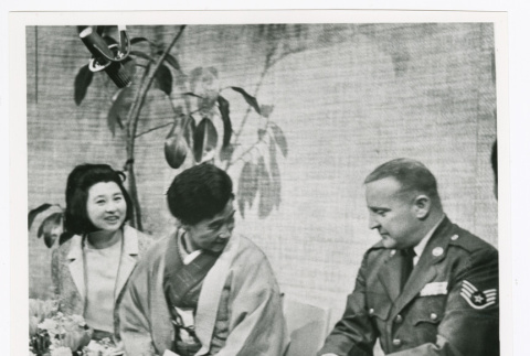 Staff Sergeant Dennis McGuire delivering letter and will of Japanese soldier Wataru Tanaka to his sister, Yoshikatsu Manabe (ddr-densho-1007-116)