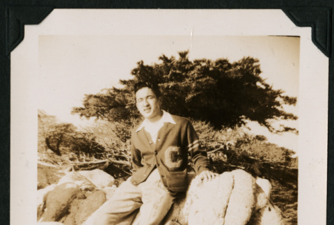 Walter Matsuoka sits on a boulder (ddr-densho-390-68)