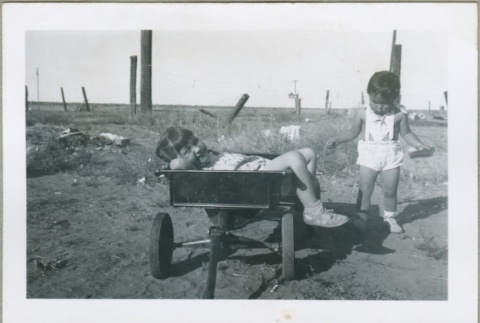 Two girls playing with a wagon (ddr-densho-300-121)