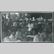 Photograph of several nurses at a Manzanar hospital staff picnic with tables in the background (ddr-csujad-47-237)