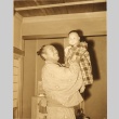 Sumo wrestler posing with a baby (ddr-njpa-4-2151)
