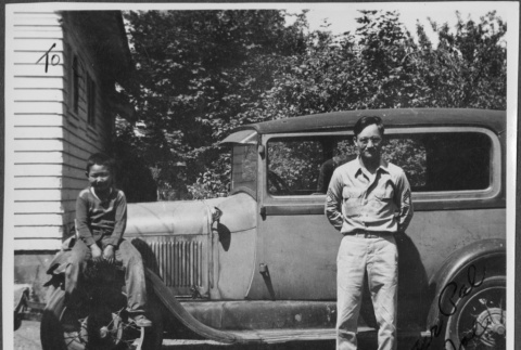 Man and boy by car (ddr-densho-434-429)