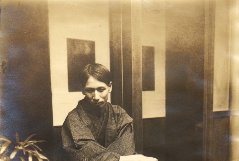 Man sitting in a courtyard (ddr-njpa-4-2578)