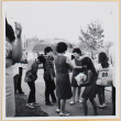 Group standing in driveway, girl holding dog (ddr-densho-522-92)