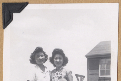 Two women outside a concentration camp barrack (ddr-densho-542-295)