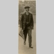 Neville Chamberlain walking with an umbrella (ddr-njpa-1-24)