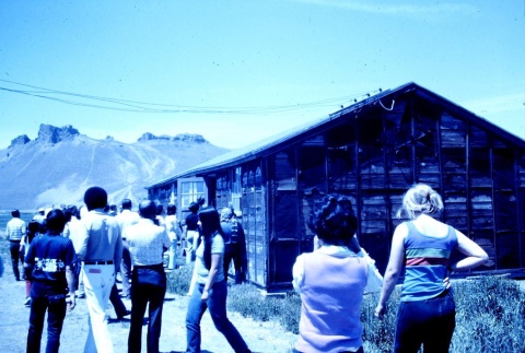 Pilgrims visiting the ruins of a barracks at Tule Lake (ddr-densho-294-45)