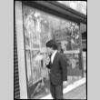 Boy looking in shop window (ddr-densho-426-2354)
