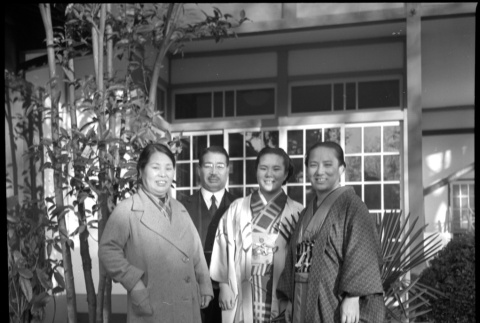 Man and three women outside building (ddr-densho-426-303)