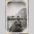 Man standing with tents in background (ddr-densho-466-658)