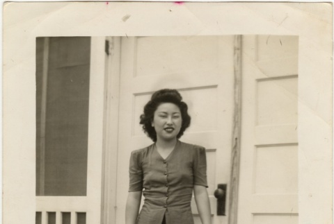 A woman standing in front of barracks (ddr-densho-331-3)