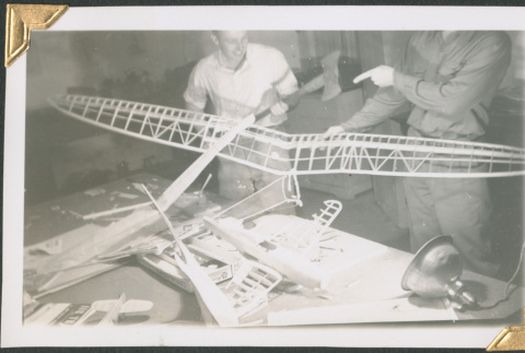 Two men working on model glider (ddr-densho-434-139)