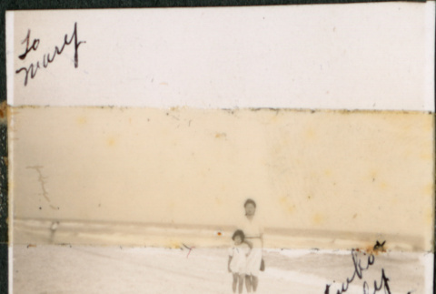 Small photo of a woman and a girl on a beach (ddr-densho-483-1311)