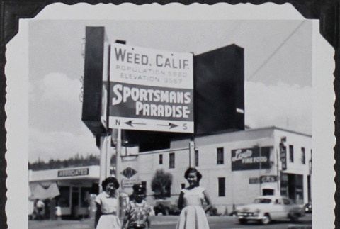 Two children posing under the Weed, California town sign (ddr-densho-300-587)