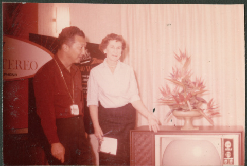Couple next to TV in electronics store (ddr-densho-523-450)