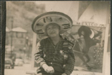 Chester Sakura Sr sitting on donkey in Nogales Mexico (ddr-densho-523-433)