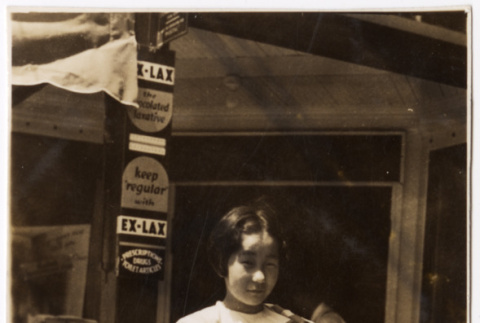 Photo of girl in front of store (ddr-densho-383-510)
