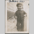 Toddler in sweater and hat walking on street (ddr-densho-483-701)