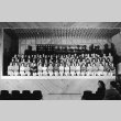 Minidoka High School students seated on an auditorium stage (ddr-fom-1-477)