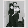 Mary Mon Toy with man holding album soundtrack for The World of Suzie Wong film (ddr-densho-367-193)