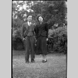 Tomoye (Nozawa) Takahashi and unidentified man standing in yard (ddr-densho-426-2180)