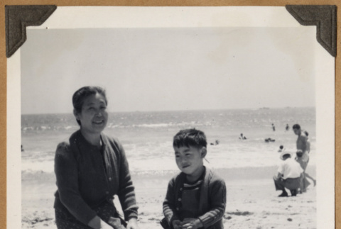 Woman and a boy at the beach (ddr-densho-542-90)