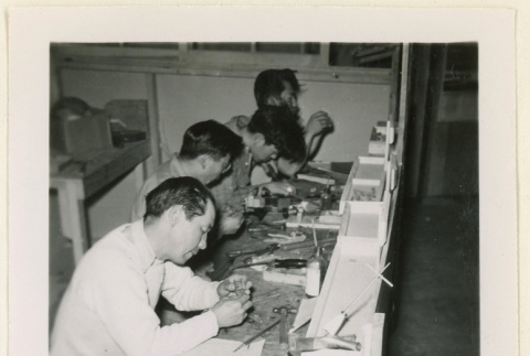 Four men work building ship models (ddr-densho-37-1355)