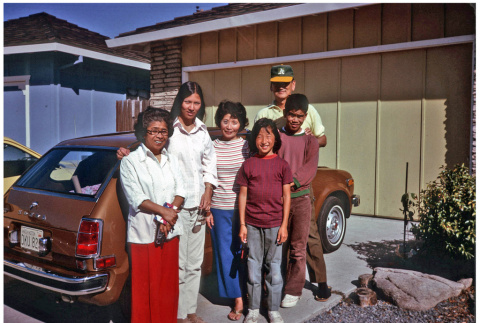 Family picture in front of car and house (ddr-densho-494-25)