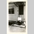 Woman sitting on a doorstep (ddr-manz-7-121)