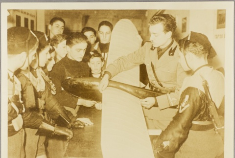 Italian officer showing a model airplane to boys in a youth auxiliary unit (ddr-njpa-13-704)
