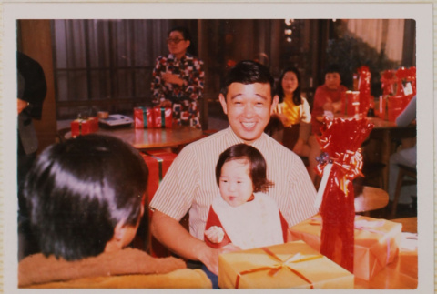 Man and toddler seated at a table (ddr-densho-426-1226)