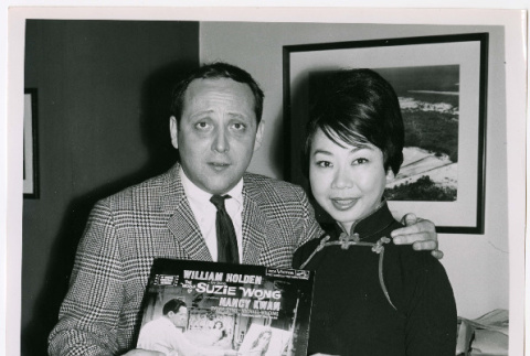 Mary Mon Toy with man holding album soundtrack for The World of Suzie Wong film (ddr-densho-367-190)