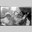Family on board ship.  Likely Tomoye (Nozawa) Takahashi with flowers on right (ddr-densho-426-1849)