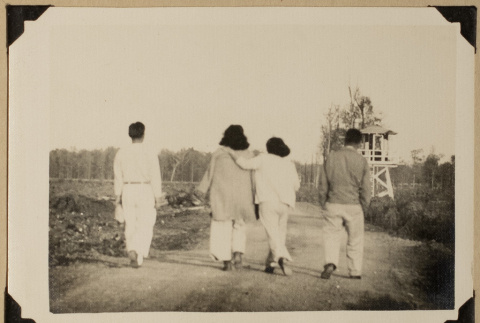 Four walking on a path (ddr-densho-542-587)