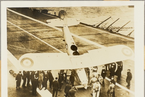 Men inspecting a plane on an aircraft carrier (ddr-njpa-13-177)