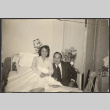 Agnes Sakura in hospital bed, with Chester Sakura seated next to her (ddr-densho-523-199)