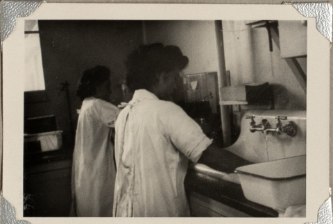 Two women washing in sink (ddr-densho-587-42)