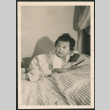 Toddler laying on bed (ddr-densho-522-739)